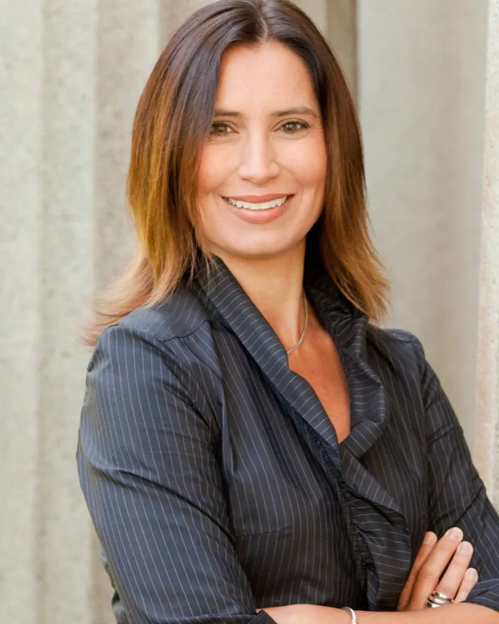 Esther A. Ralich, attorney, standing before a stone column